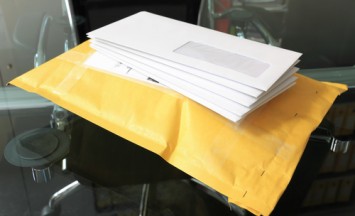 pile of paper mails over parcel post in office
